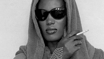 Grace Jones in 1984 wearing retro-futuristic black glasses, symbolizing her bold and liberated style.