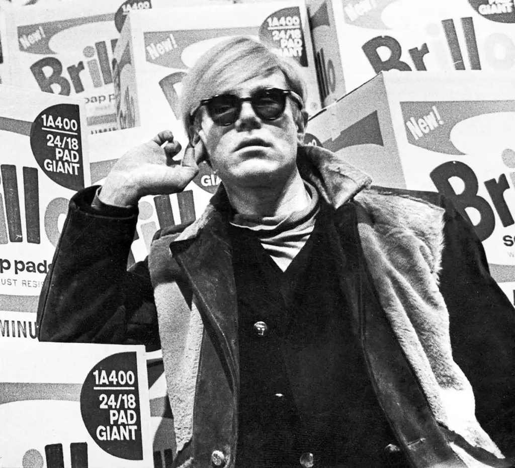 Andy Warhol's glasses. Andy Warhol wearing Ray-Ban Wayfarer glasses in front of Brillo boxes, 1968.