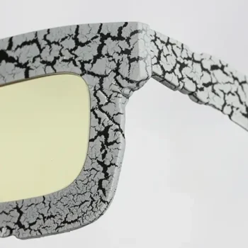 Close-up of Brutalist Sun sunglasses by T-Generations, crafted in titanium with a cracked texture inspired by Brutalist architecture.