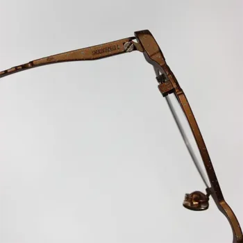 Detail of the hinge on Concrete Anchor glasses by T-Generations, crafted in titanium with a textured bronze finish.
