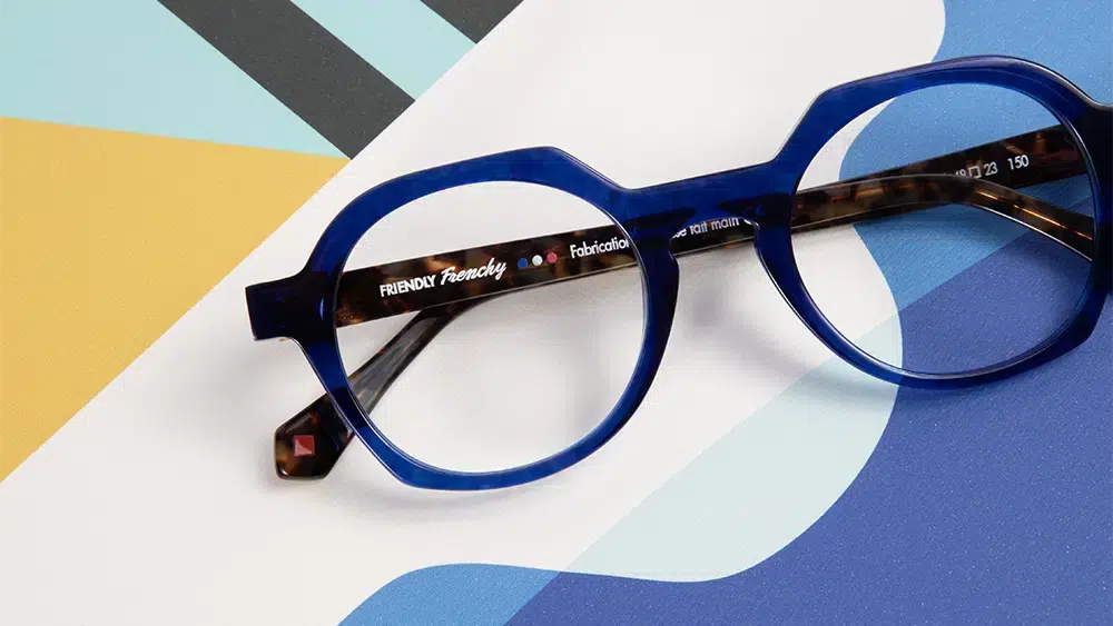 Friendly Frenchy Sunglasses Made from Recycled Materials, Blue Model on a Colorful Graphic Background