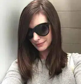 Anne Hathaway wearing Oliver Goldsmith Manhattan sunglasses, an iconic model inspired by the 1960s.