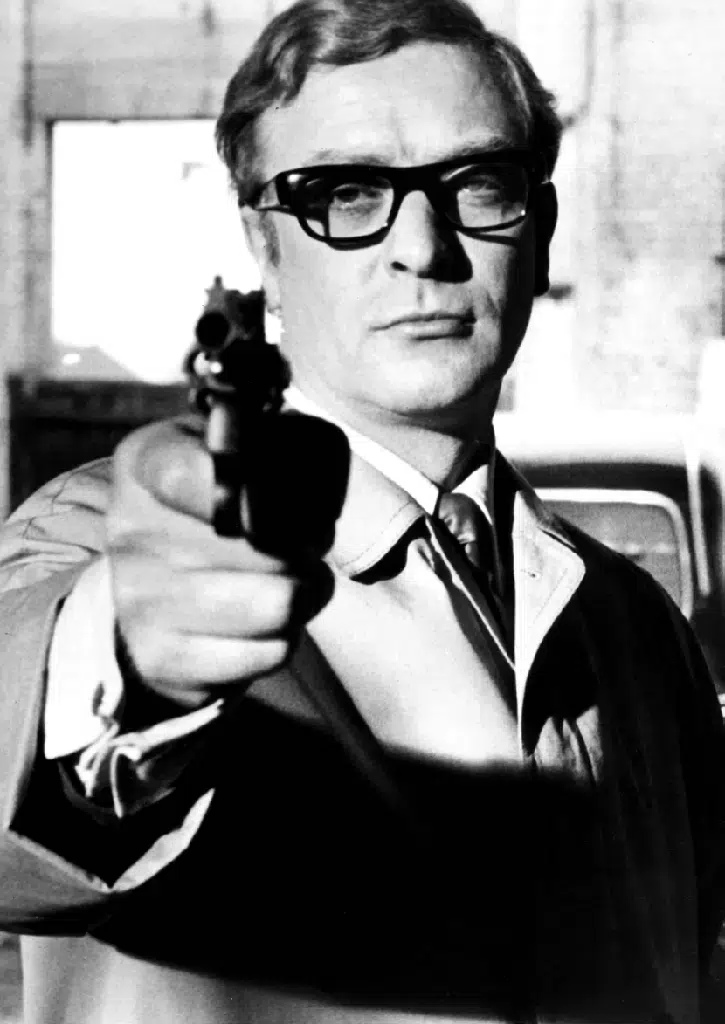 Michael Caine wearing Oliver Goldsmith Lord glasses in the 1965 film The Ipcress File, an emblematic model of British vintage style.