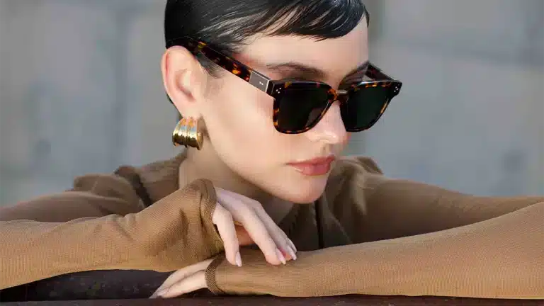 Luxury eyewear: tortoiseshell rectangular frame worn by a woman with an elegant look