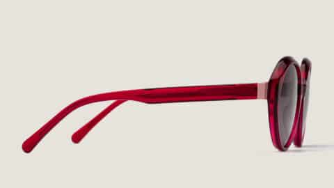 Gafas de sol Fiamma, montura redonda rojo transparente, vista de perfil, lentes grises